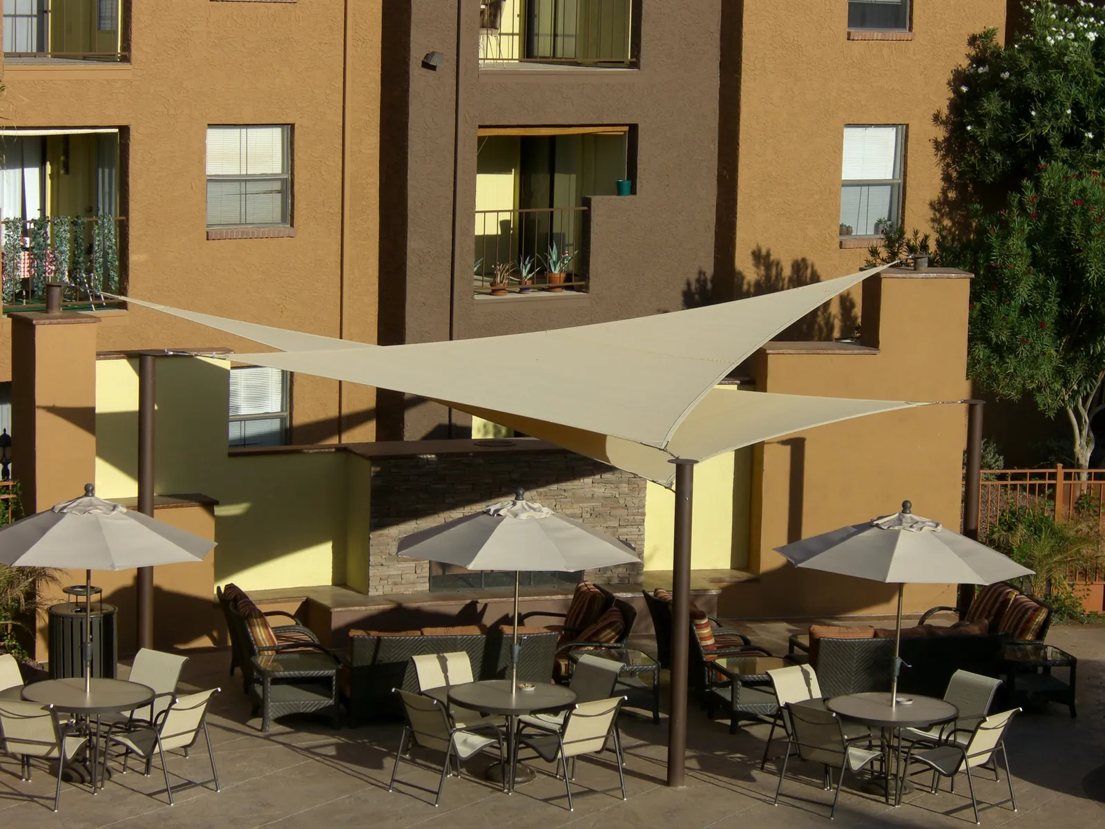 Shade sails over a community courtyard with seating